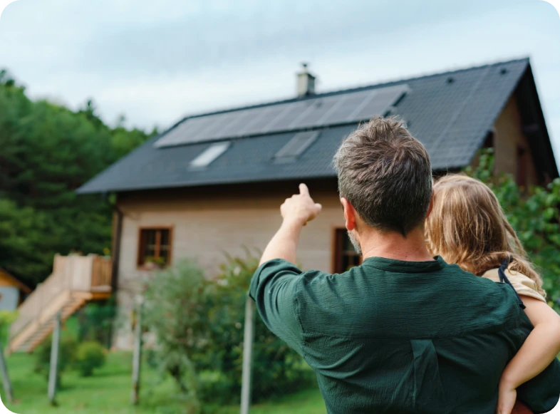 Homme montrant une maison du doigt